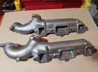 Oldsmobile V8 Exhaust Manifolds - Two Right Side Used. Price: $175.00.